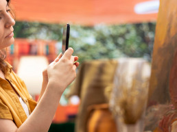 une femme prenant une photo d'une oeuvre d'art